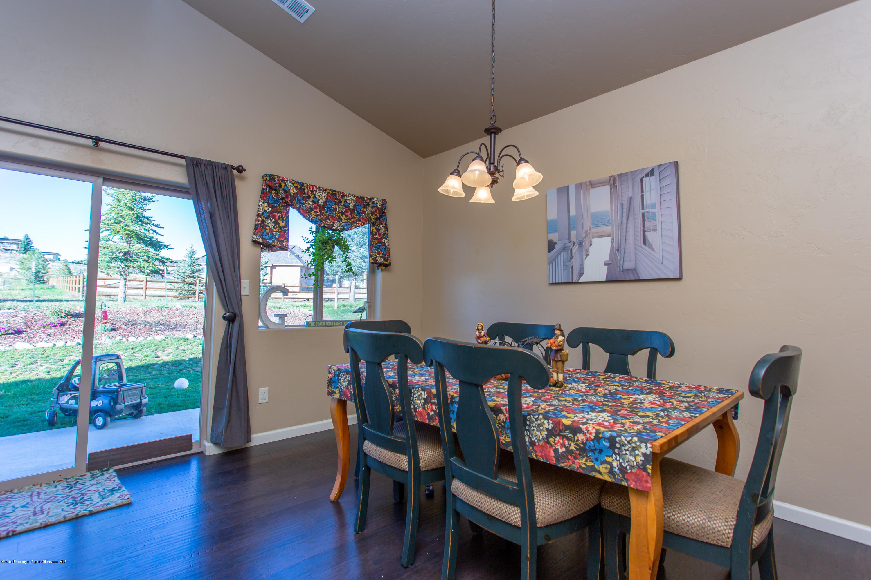 1930 Promontory Circle Rifle, CO 81650 - Photo 5 of 19 a view of a dining room with furniture window and wooden floor