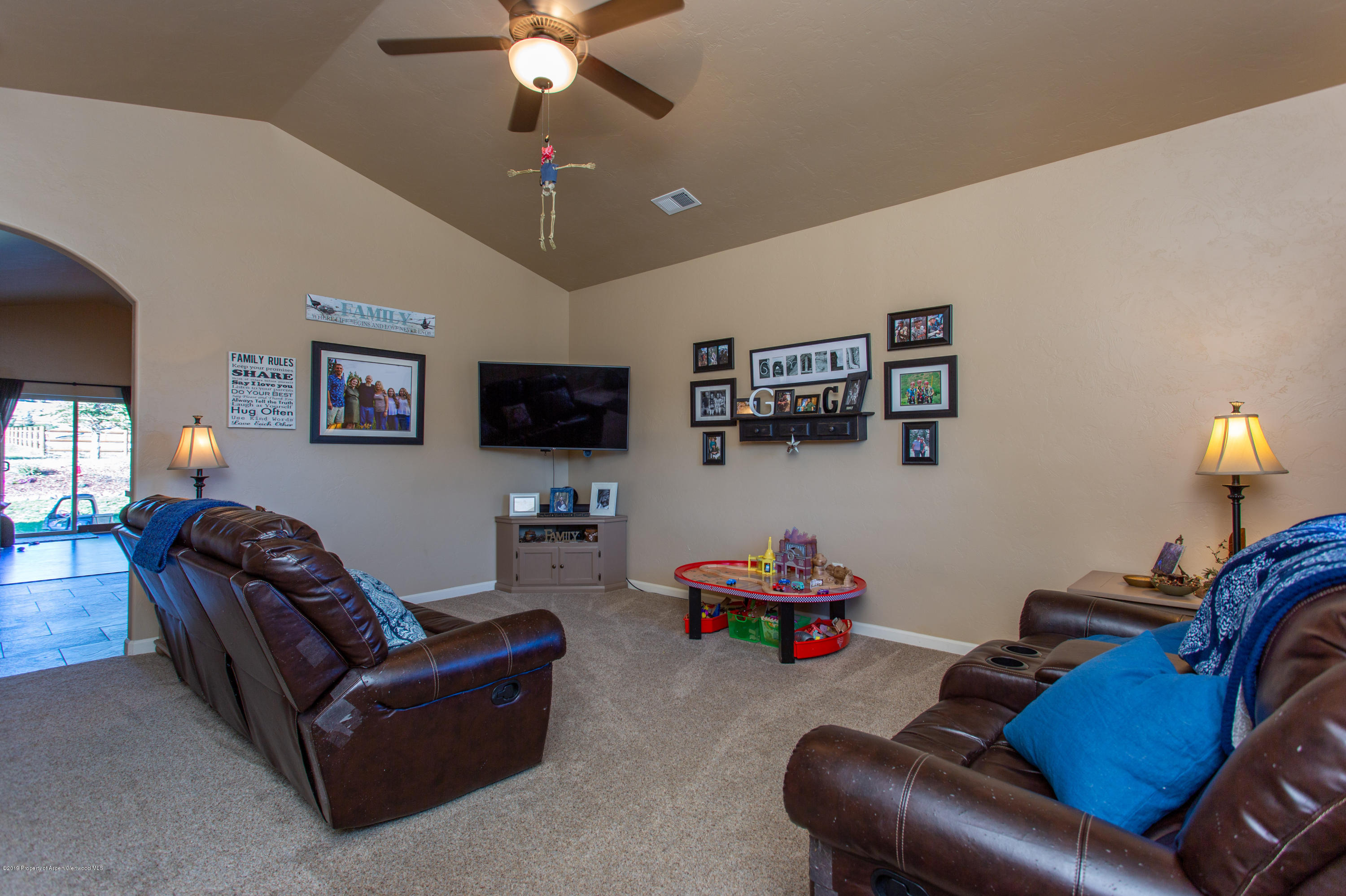 1930 Promontory Circle Rifle, CO 81650 - Photo 7 of 19 a living room with furniture and a flat screen tv