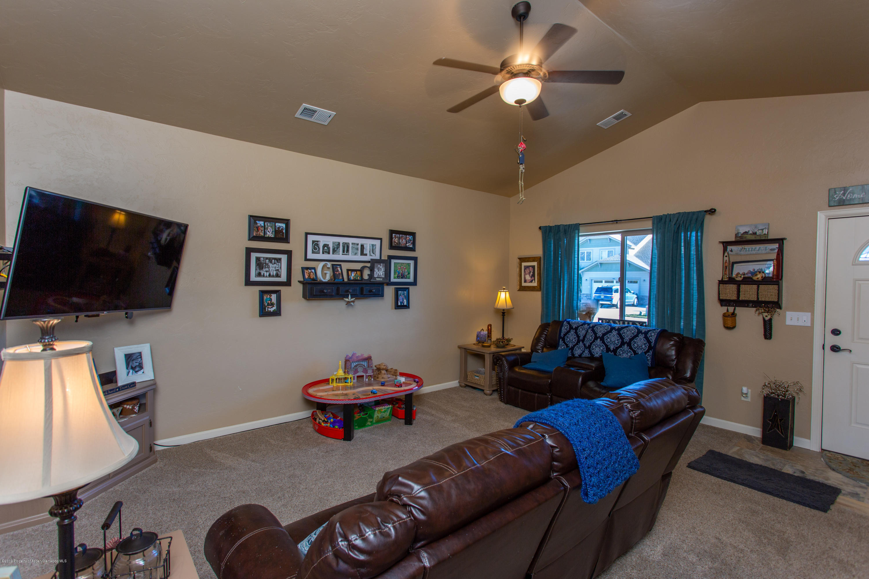 1930 Promontory Circle Rifle, CO 81650 - Photo 8 of 19 a living room with furniture and a flat screen tv