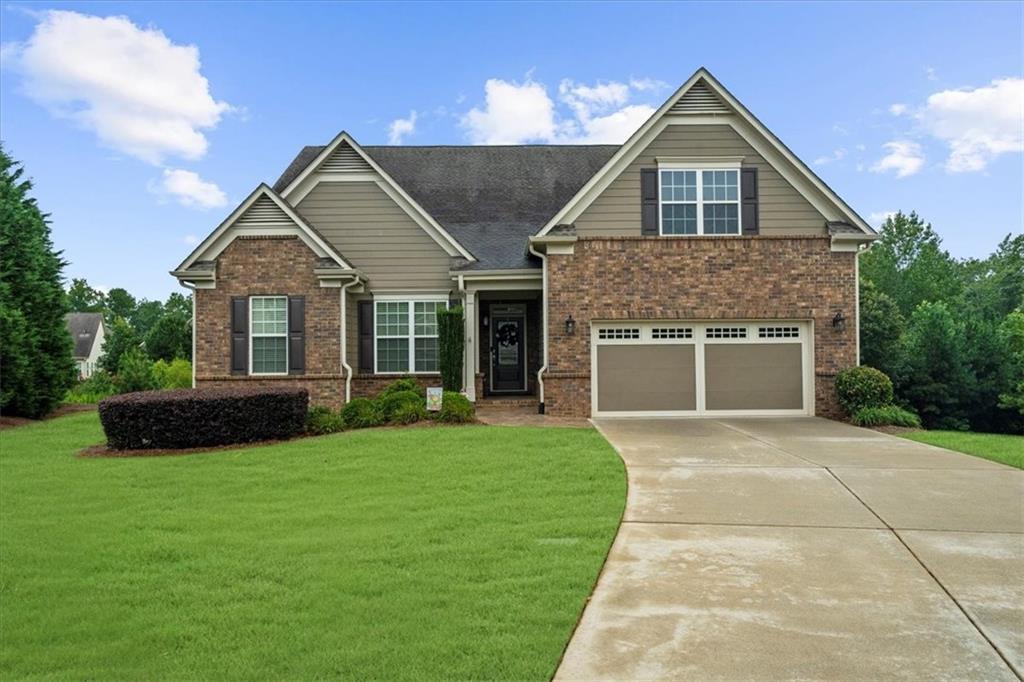 3709 Maple Shade Drive Southwest Gainesville, GA 30504 - Photo 1 of 81 a front view of a house with a garden and yard