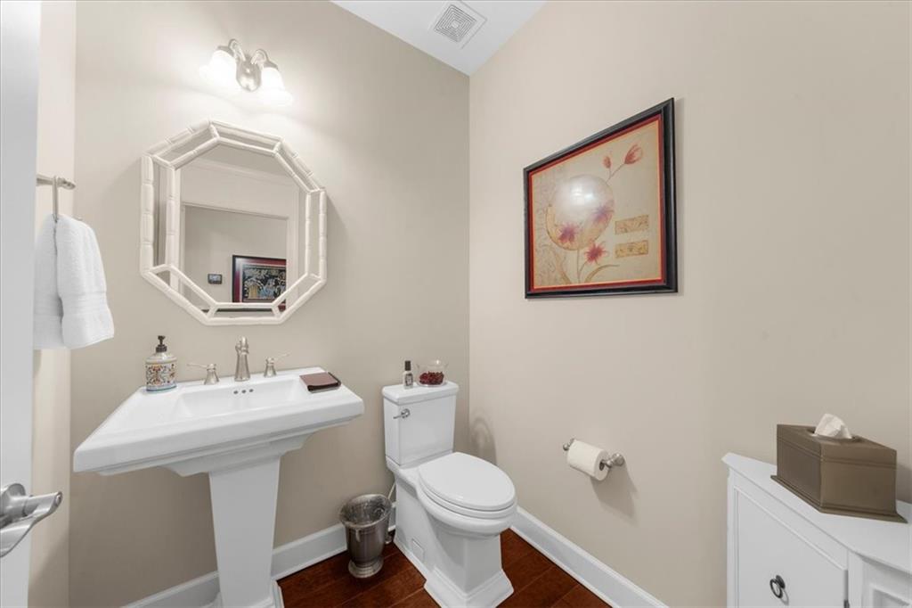 3709 Maple Shade Drive Southwest Gainesville, GA 30504 - Photo 41 of 81 a bathroom with a toilet a sink and mirror