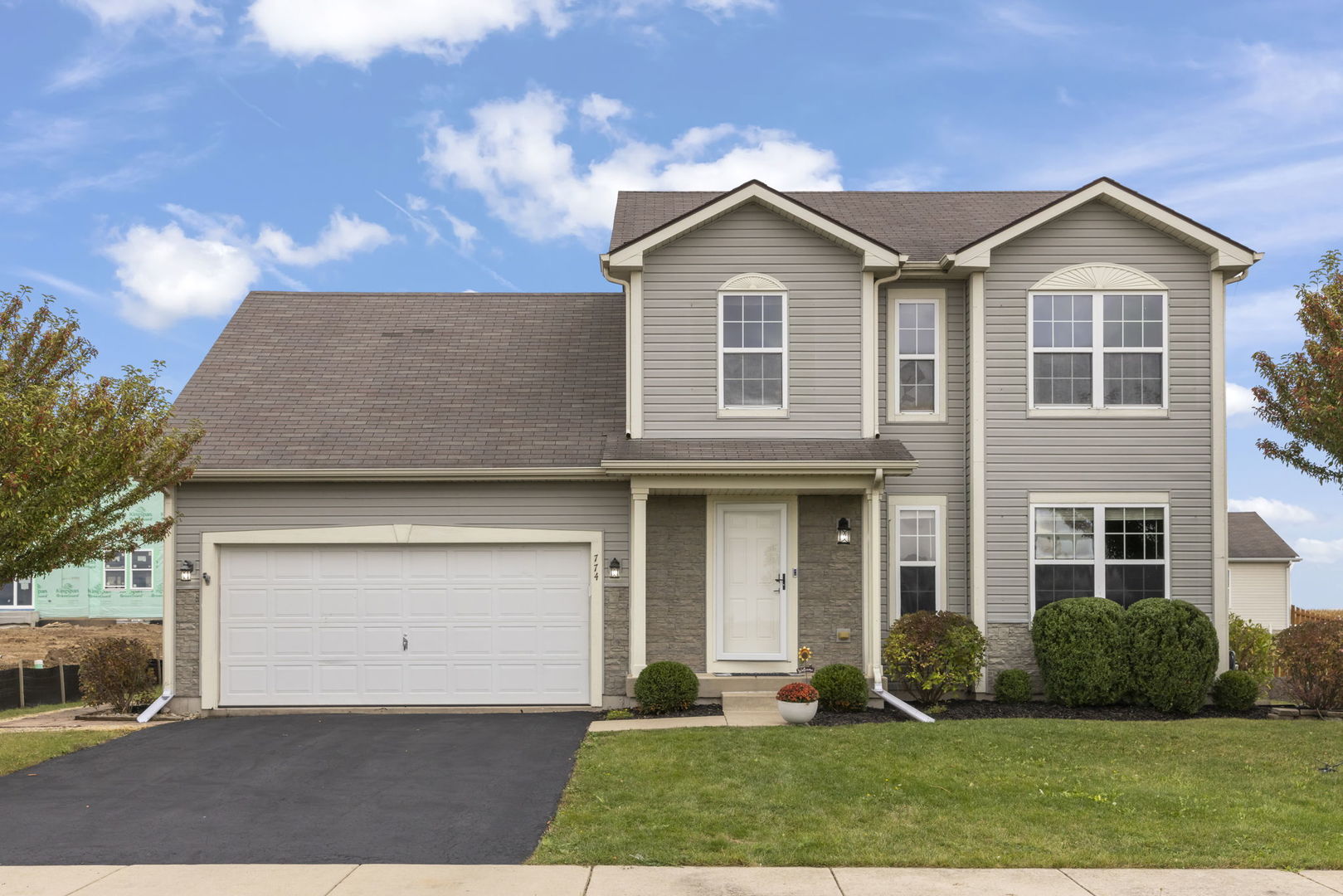 a front view of a house with a yard and garage