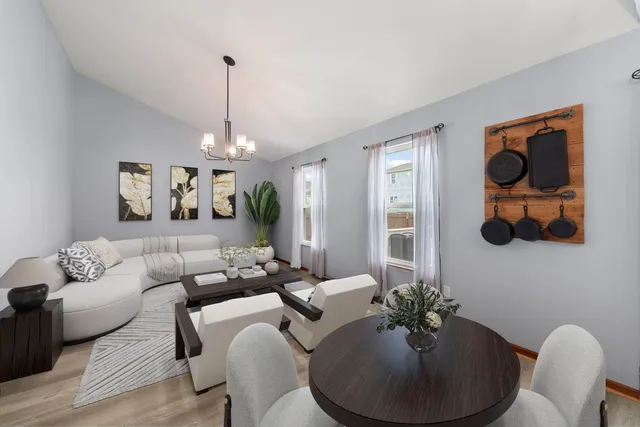 a living room with furniture and a chandelier