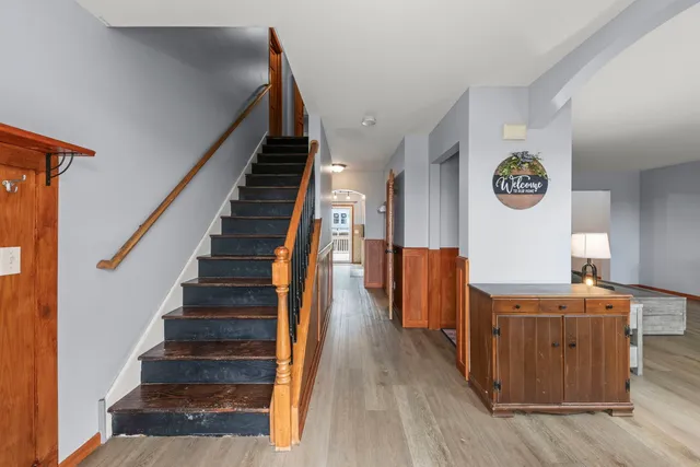 a view of a hallway with wooden floor and entryway