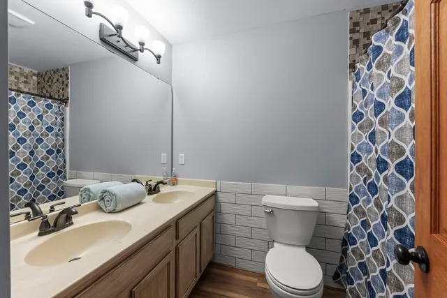 a bathroom with a sink toilet and shower
