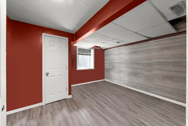 a view of an empty room and wooden floor