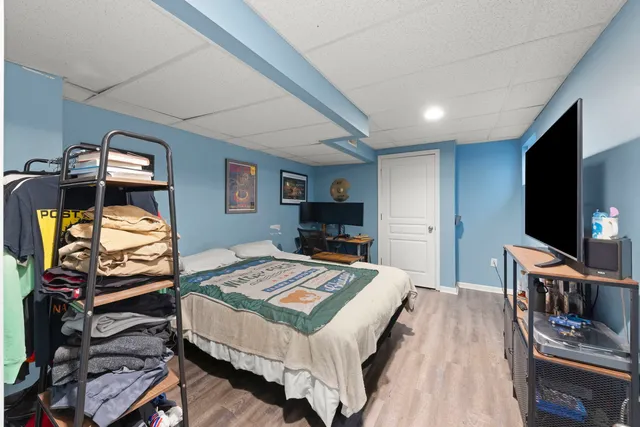 a bedroom with a bed and a flat screen tv