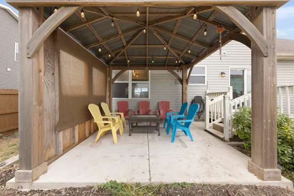 a view of sitting area in balcony with chairs