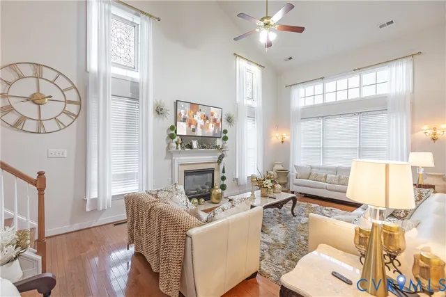 a living room with fireplace furniture and a large window