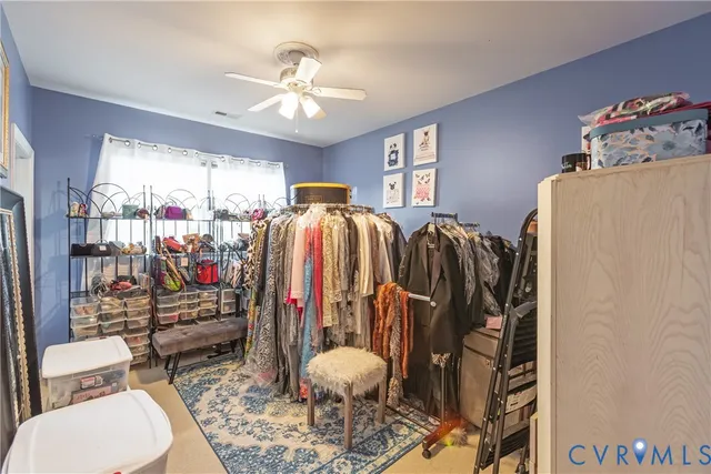 a walk in closet with a washer and dryer