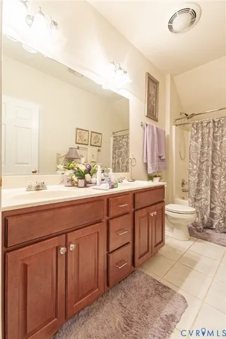 a bathroom with a double vanity sink mirror and bathtub
