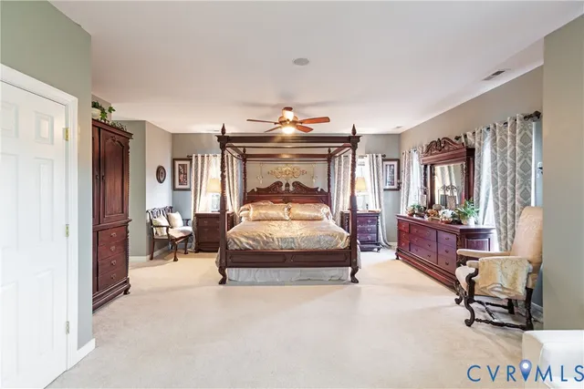 a bedroom with a bed and large mirror