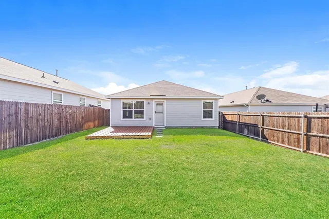 a view of a house with a yard and sitting area