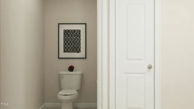 a white toilet sitting next to a small bathroom