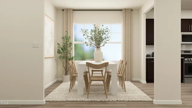 a view of a dining room with furniture and a potted plant