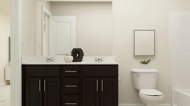 a bathroom with a sink a toilet and mirror