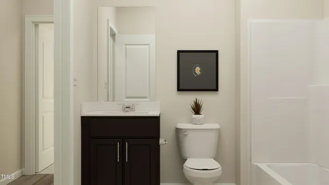 a bathroom with a toilet sink a mirror and vanity