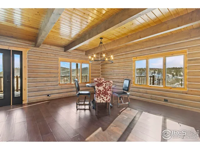 a dining room with furniture and wooden floor