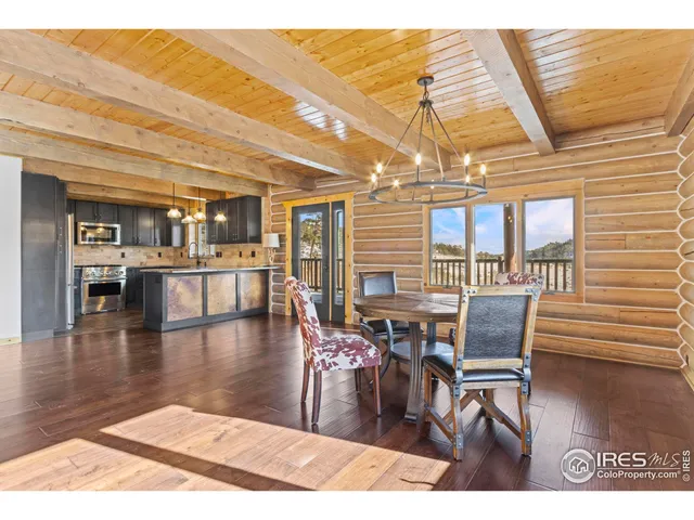 a dining room with furniture and wooden floor