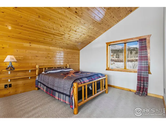 a spacious bedroom with a bed and a window