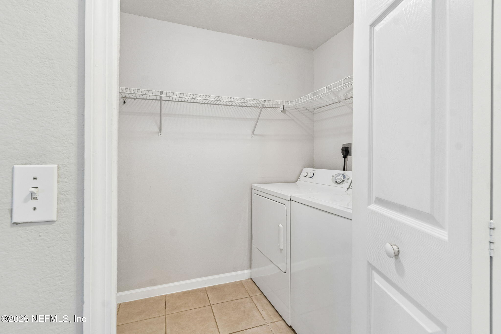 8550 Touchton Road, Unit 511 Jacksonville, FL 32216 - Photo 21 of 63 a utility room with cabinets washer and dryer