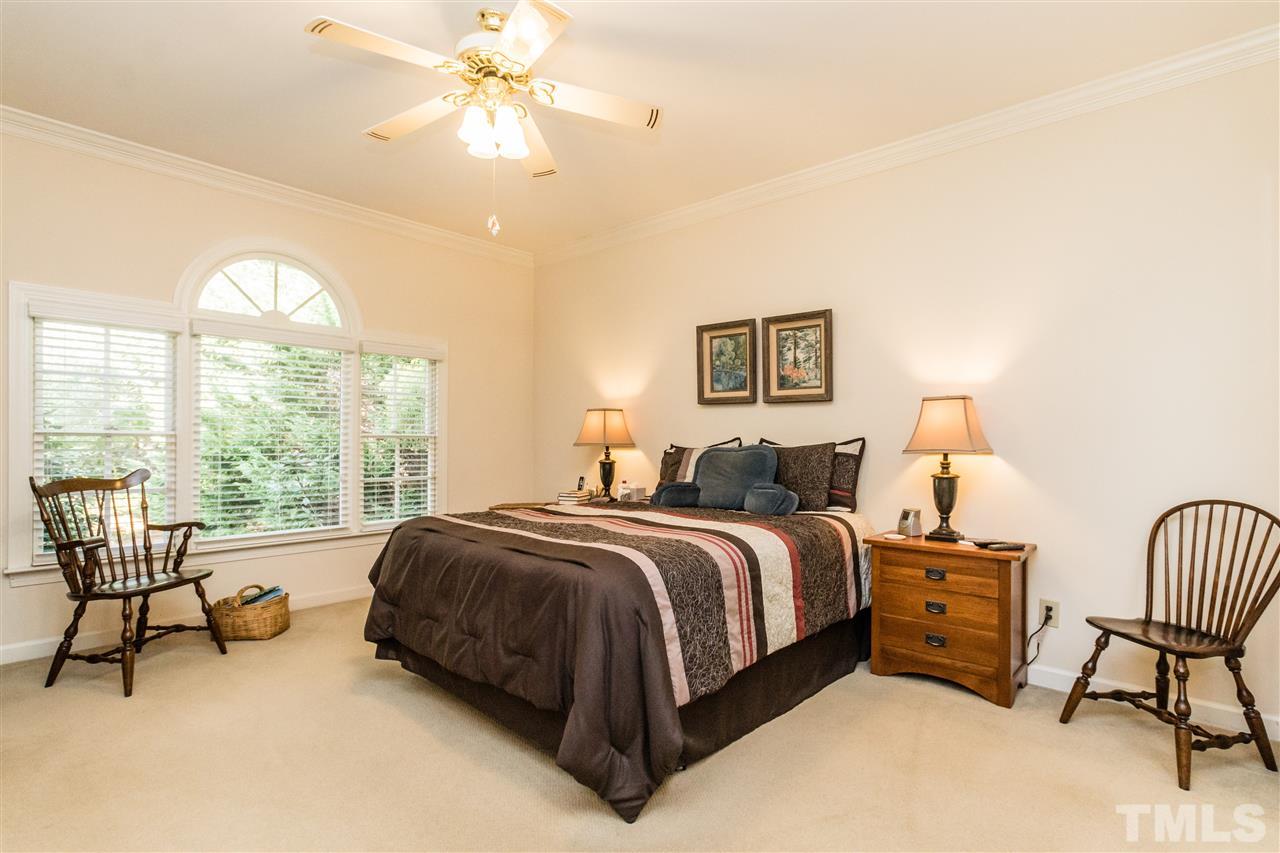 3324 Harden Road Raleigh, NC 27607 - Photo 14 of 25 a spacious bedroom with a bed and a chandelier