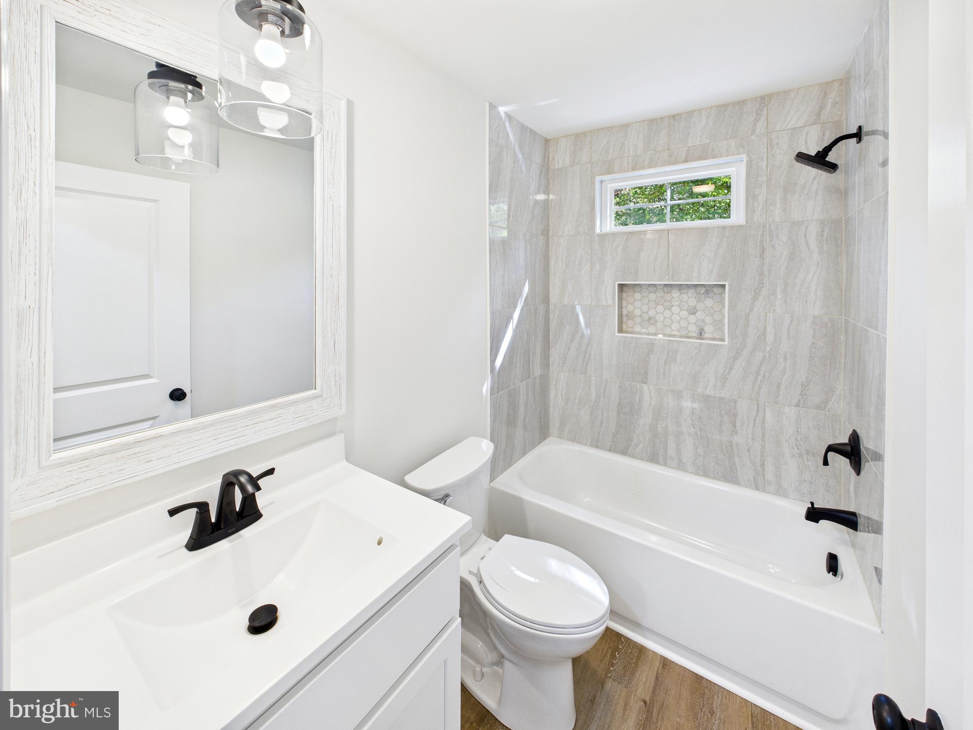 22202 Wetipquin Road Quantico, MD 21856 - Photo 13 of 42 a bathroom with a sink a toilet and a bathtub