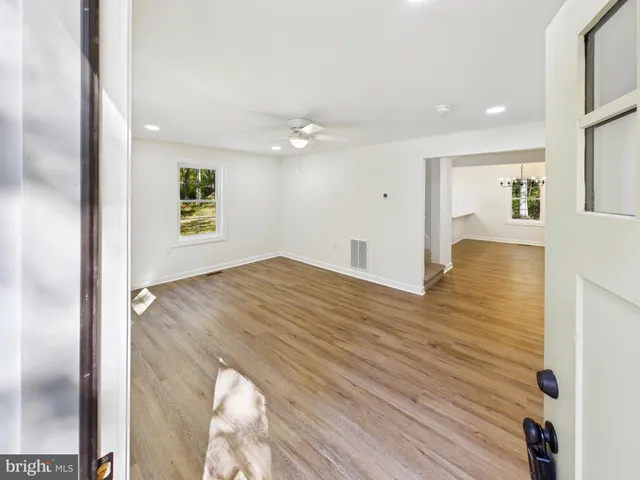 a view of kitchen and hall with wooden floor