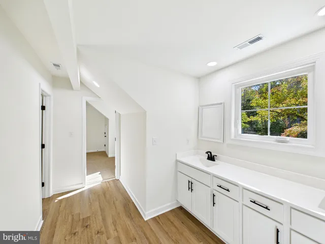 a bathroom with a sink and a large mirror