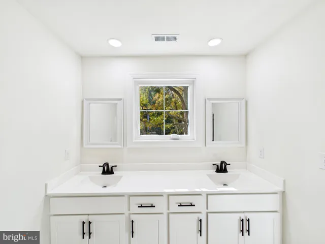 a bathroom with a sink and a window