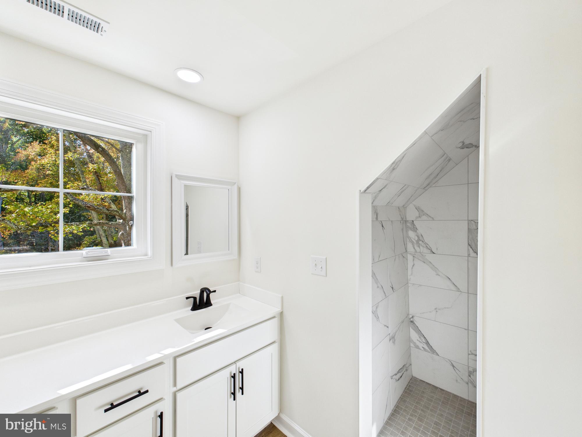 22202 Wetipquin Road Quantico, MD 21856 - Photo 25 of 42 a bathroom with a sink a toilet and a window