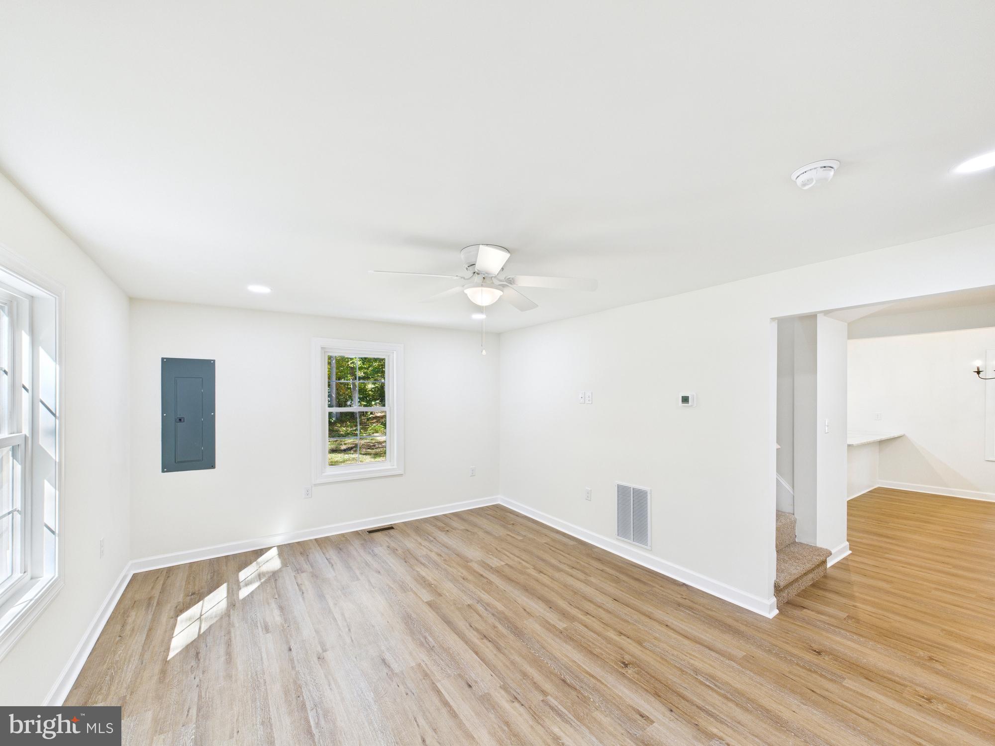 22202 Wetipquin Road Quantico, MD 21856 - Photo 3 of 42 a view of empty room with wooden floor and fan