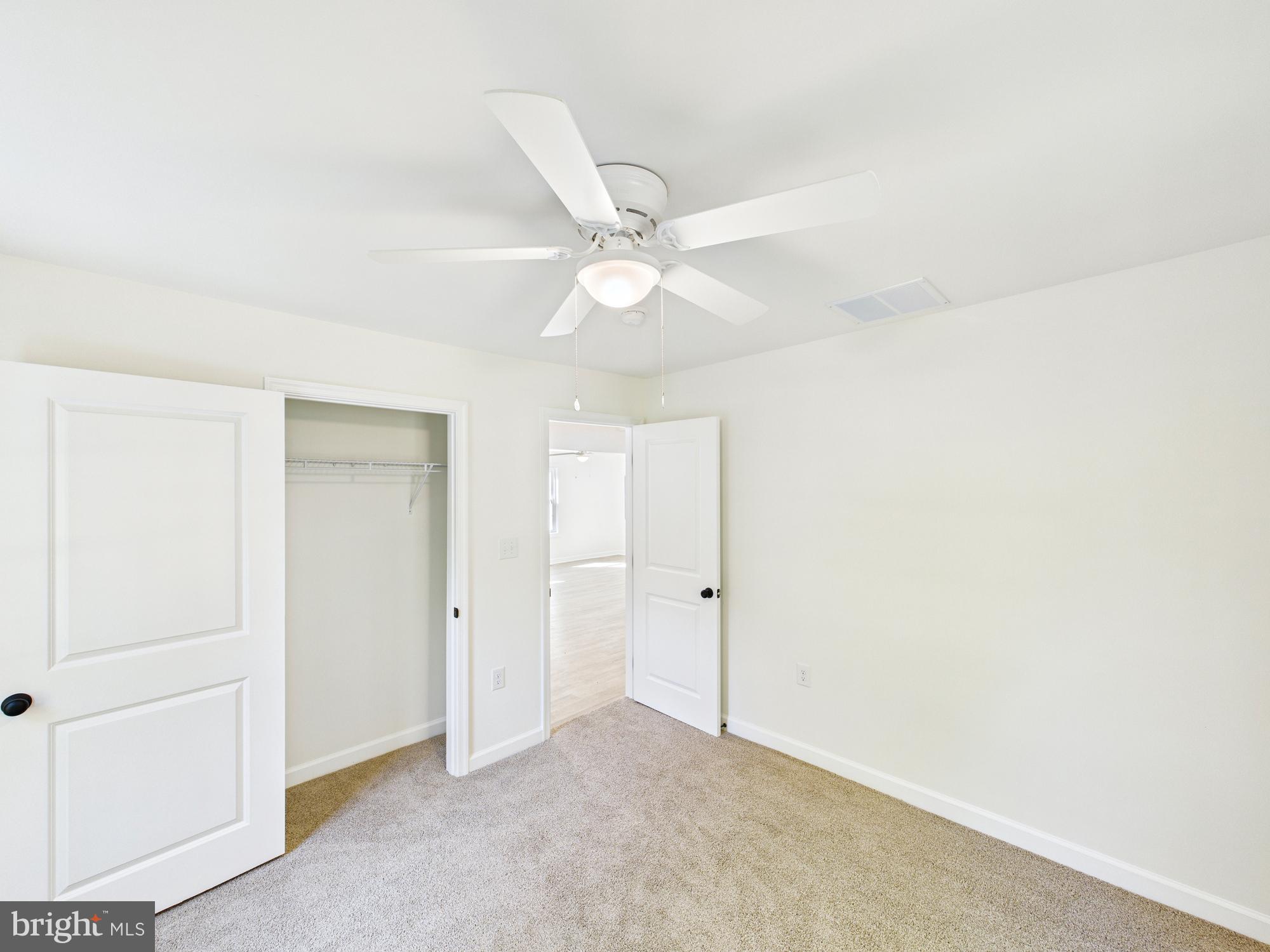 22202 Wetipquin Road Quantico, MD 21856 - Photo 31 of 42 an empty room with a ceiling fan and a ceiling fan
