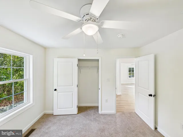 an empty room with windows and entrance