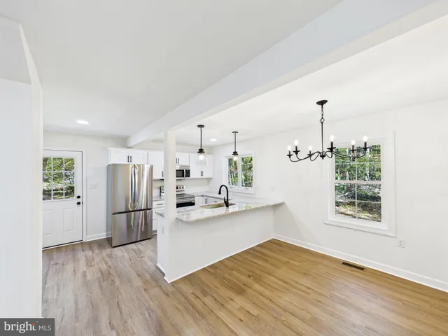 a kitchen with stainless steel appliances a refrigerator and a stove top oven