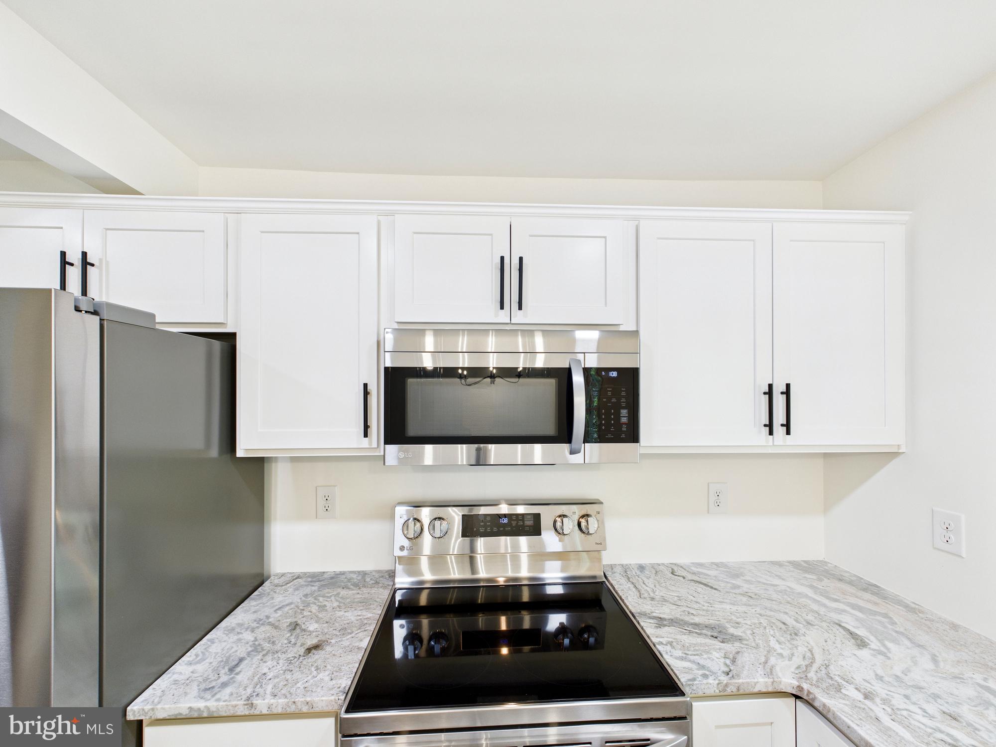 22202 Wetipquin Road Quantico, MD 21856 - Photo 10 of 42 a kitchen with stainless steel appliances granite countertop a sink stove and refrigerator