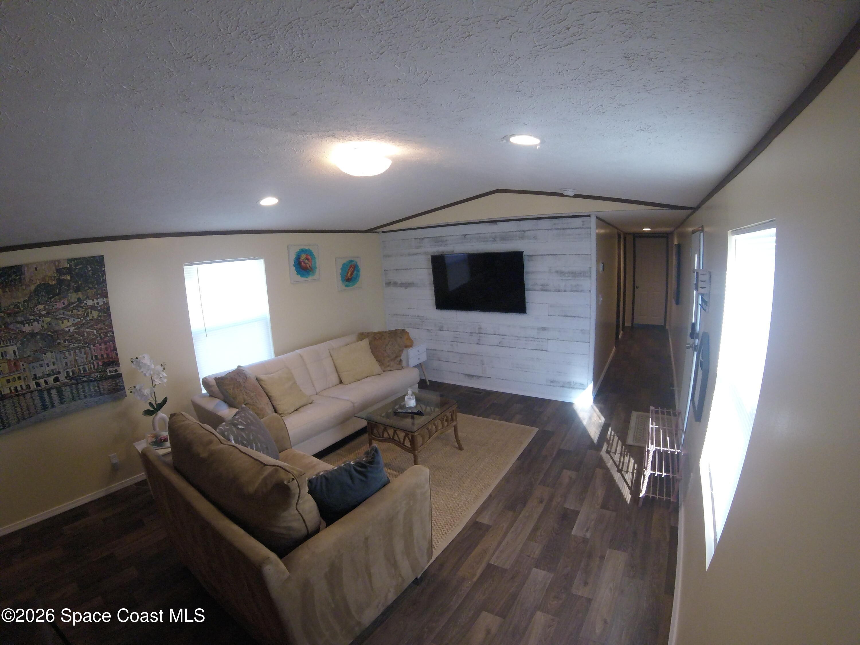 2501 Amberly Road Northeast Palm Bay, FL 32905 - Photo 15 of 25 a living room with furniture and a flat screen tv