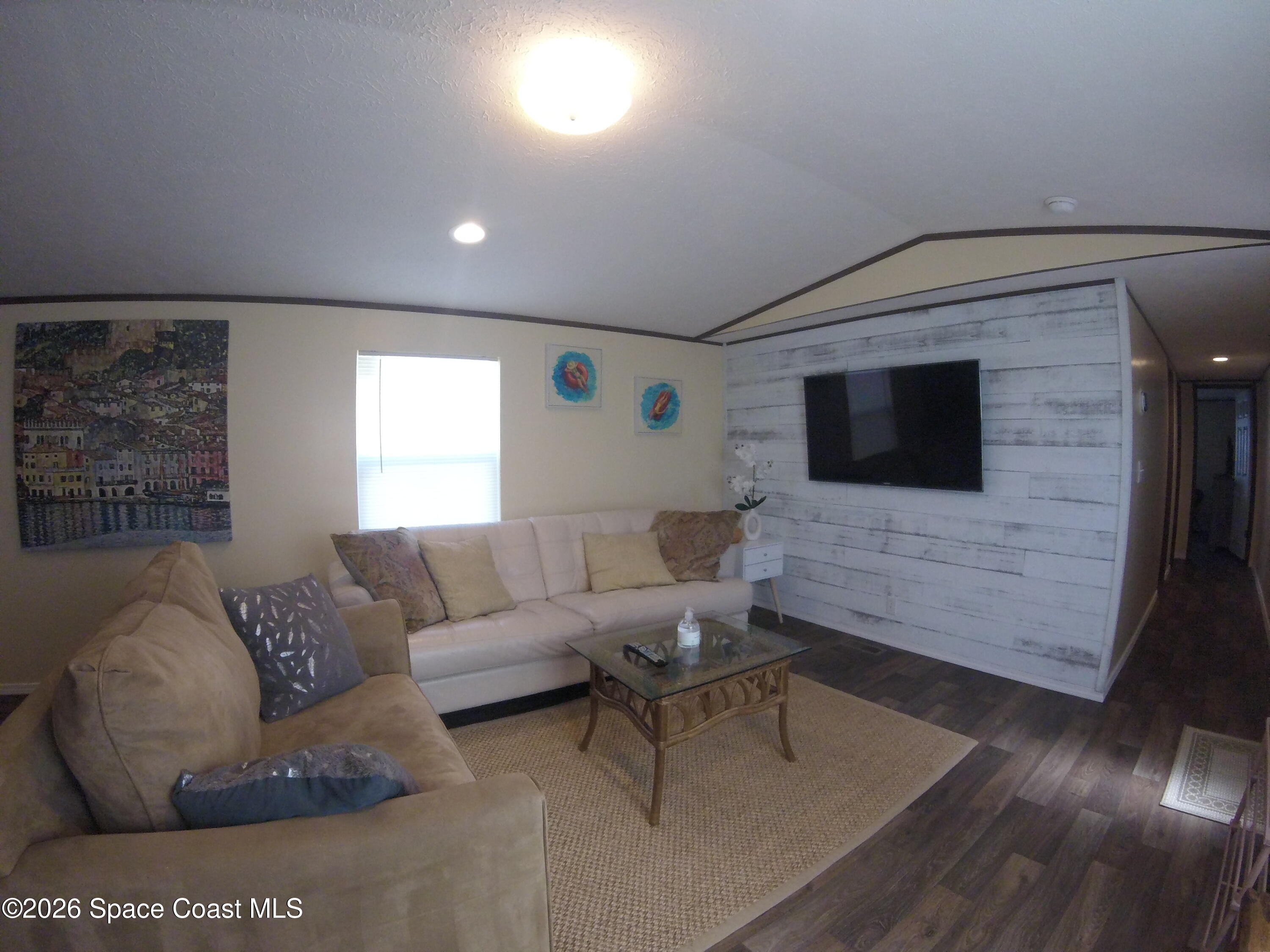 2501 Amberly Road Northeast Palm Bay, FL 32905 - Photo 16 of 25 a living room with furniture and a flat screen tv