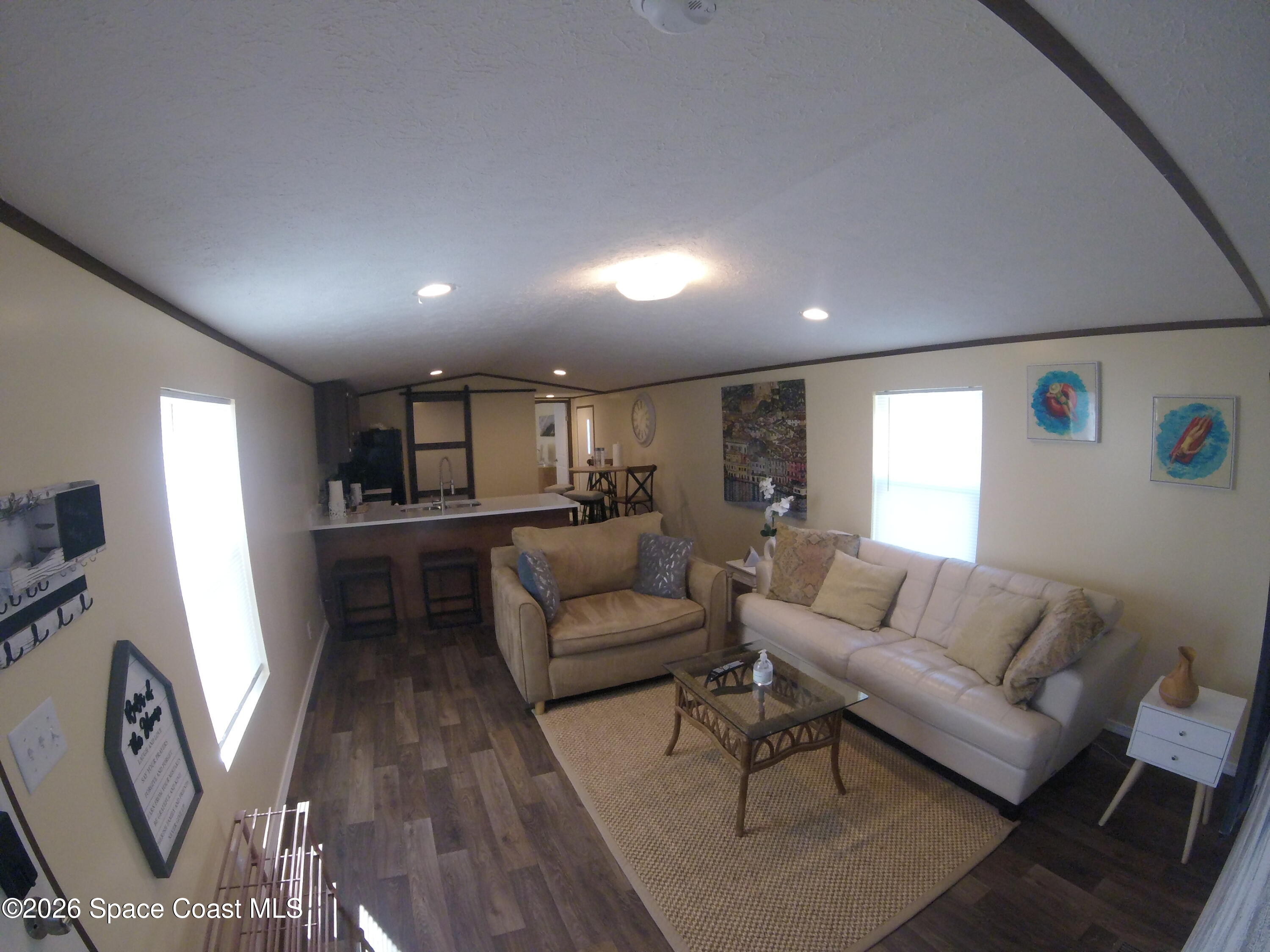 2501 Amberly Road Northeast Palm Bay, FL 32905 - Photo 18 of 25 a living room with furniture and a large window