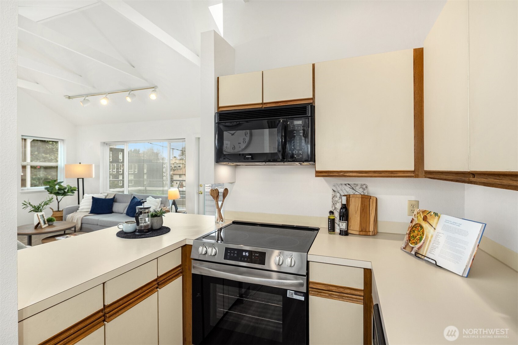 57 Etruria Street, Unit 201 Seattle, WA 98109 - Photo 14 of 26 a kitchen with a sink a stove and cabinets