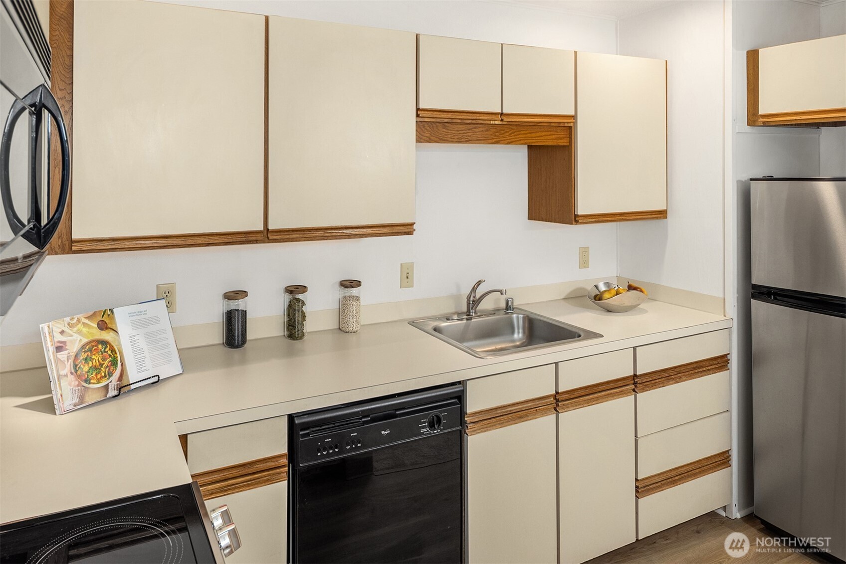 57 Etruria Street, Unit 201 Seattle, WA 98109 - Photo 15 of 26 a kitchen with stainless steel appliances granite countertop a sink stove and refrigerator