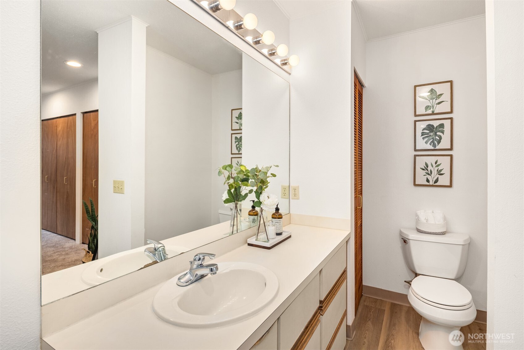 57 Etruria Street, Unit 201 Seattle, WA 98109 - Photo 20 of 26 a bathroom with a toilet sink and mirror
