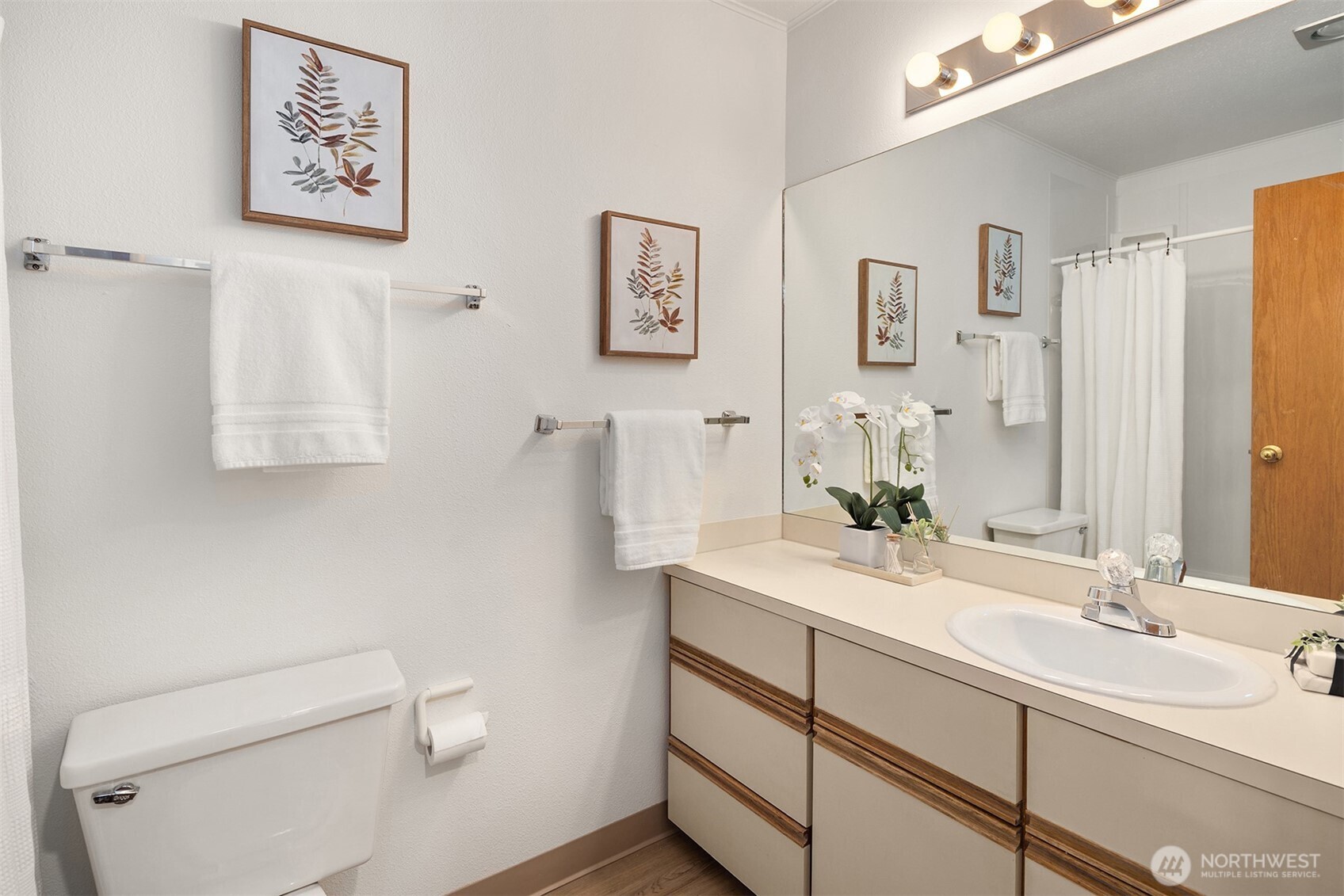 57 Etruria Street, Unit 201 Seattle, WA 98109 - Photo 22 of 26 a bathroom with a double vanity sink mirror and toilet