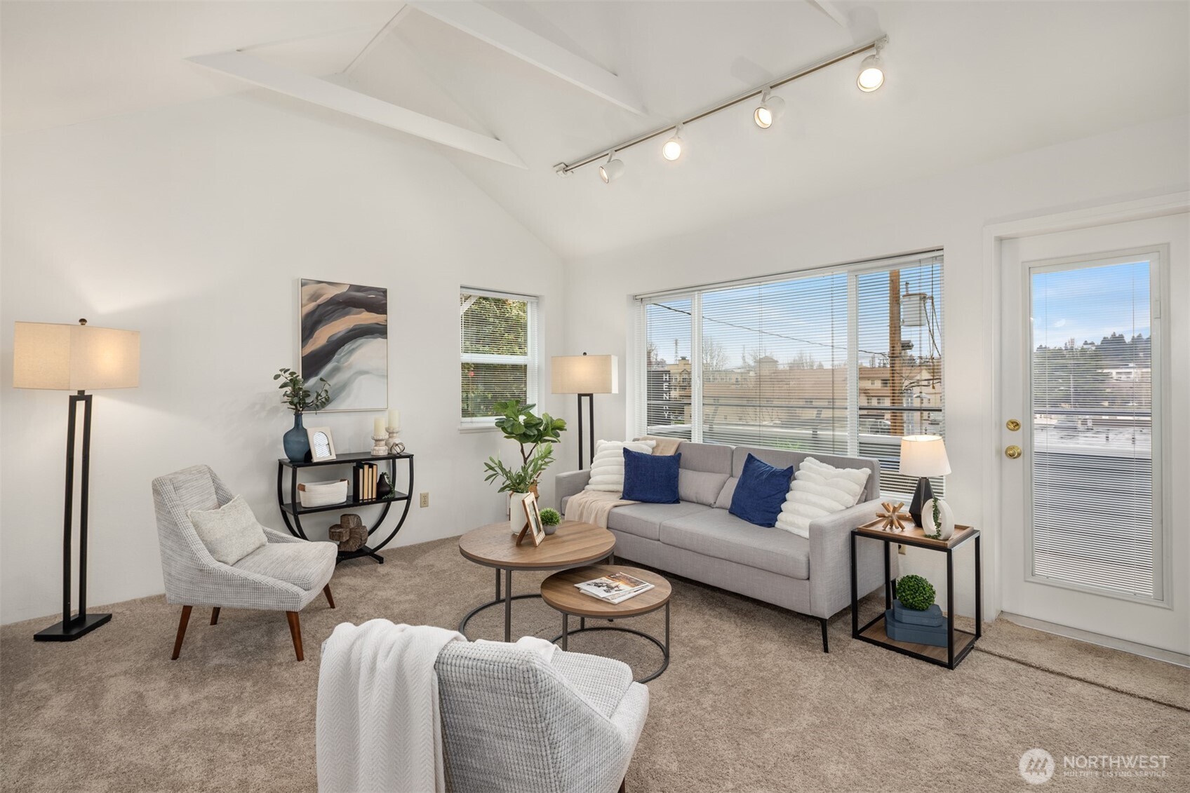 57 Etruria Street, Unit 201 Seattle, WA 98109 - Photo 4 of 26 a living room with furniture and a floor to ceiling window