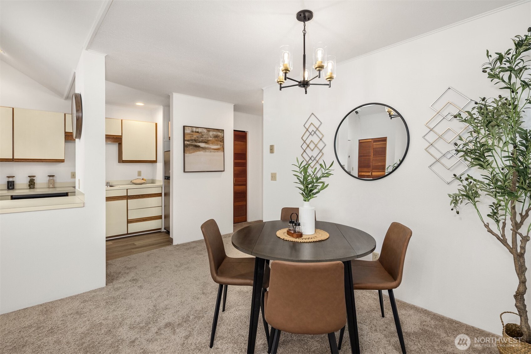 57 Etruria Street, Unit 201 Seattle, WA 98109 - Photo 9 of 26 a dining room with furniture and a chandelier