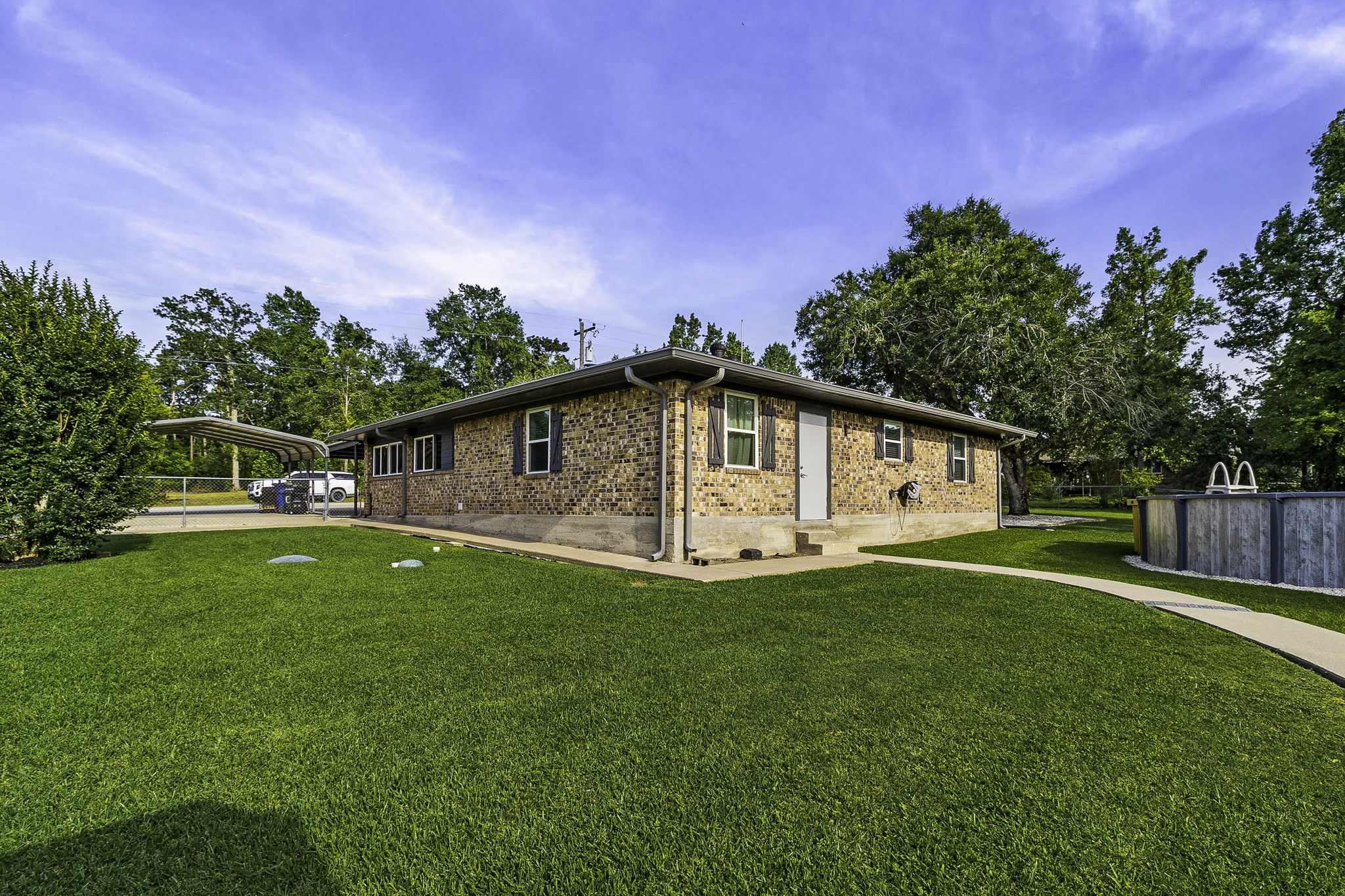188 Huckleberry Road Onalaska, TX 77360 - Photo 32 of 49 a front view of a house with a yard