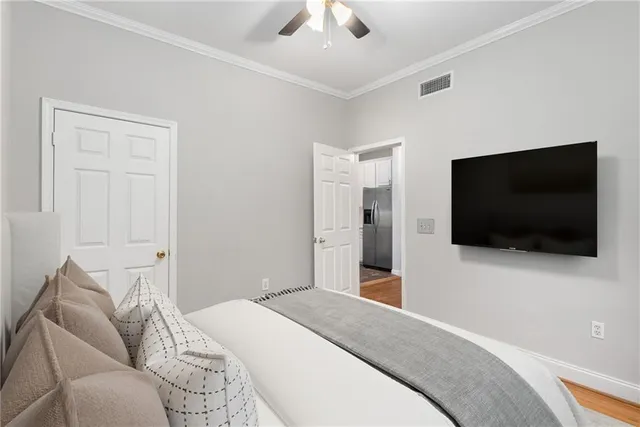 a view of a livingroom with wooden floor and staircase