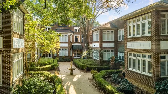 a view of a brick house next to a yard