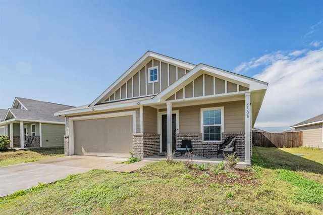 a view of a house with backyard porch and sitting area