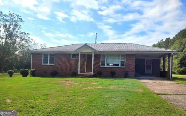 a front view of a house with garden and porch